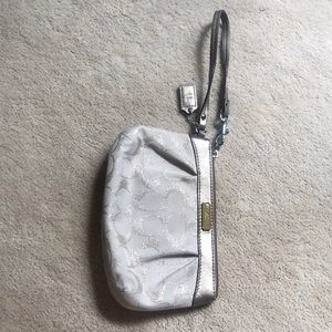 White/gold Coach wristlet